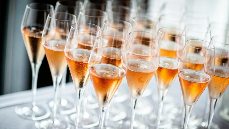 Champagne glasses filled with sparkling wine on a white table