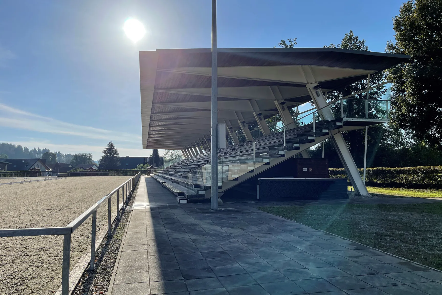 Horse arena with grandstand seating in the sunshine